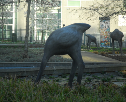 Photo of statues of ostriches with their heads in the sand in front of the European Parliament